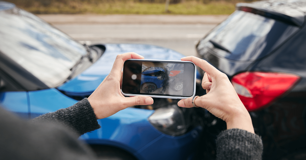 Photo of a woman taking a photo after a car accident